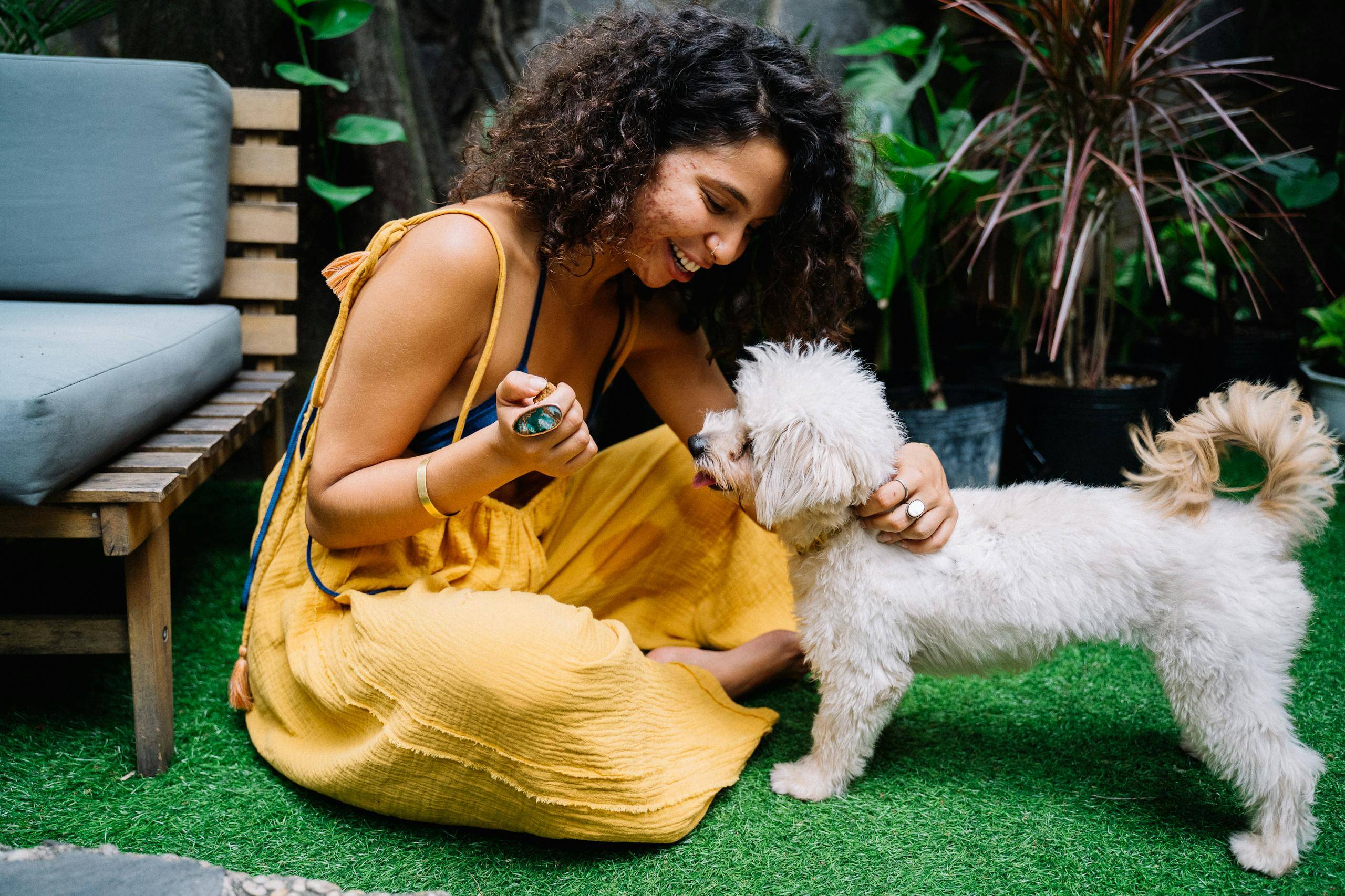 Curly Hair Woman Playing with the Dog